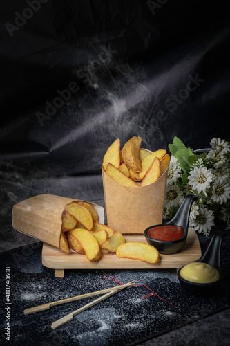 Potato wedges are made of potatoes with skin and cut into pieces. They’re usually cut into big and thick pieces. When fried, you will feel the crispiness of the skin and the softness of the flesh. photo