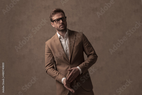 Obraz na plátne sexy tough businessman rubbing his palms, wearing eyeglasses