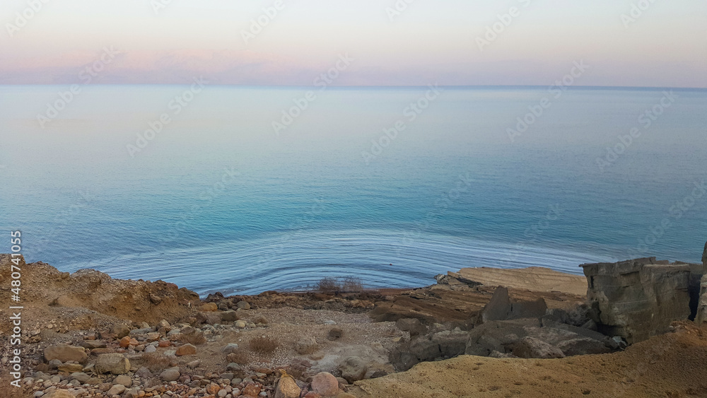 View of Dead Sea coastline. Salt crystals at sunset. Texture of Dead sea. Salty sea shore. Landscape Dead Sea coastline in summer day, failures of the soil View of Dead Sea coastline. Salt crystals at sunset. Texture of Dead sea. Salty sea shore. Landscape Dead Sea coastline in summer day, failures of the soil