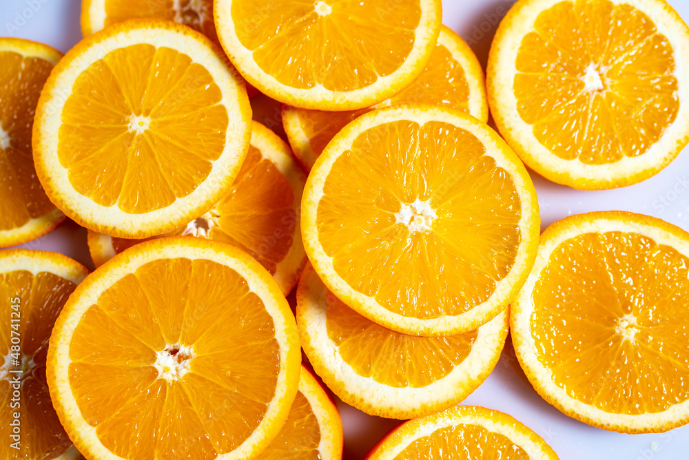 Fototapeta premium Fresh slised oranges on white background. Top view.