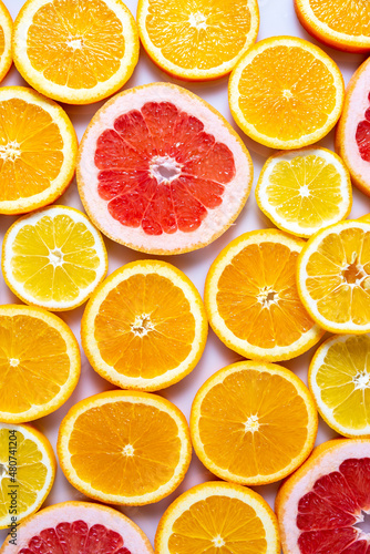 Slises of different citruses on the white background. Close-up of slised citruses.