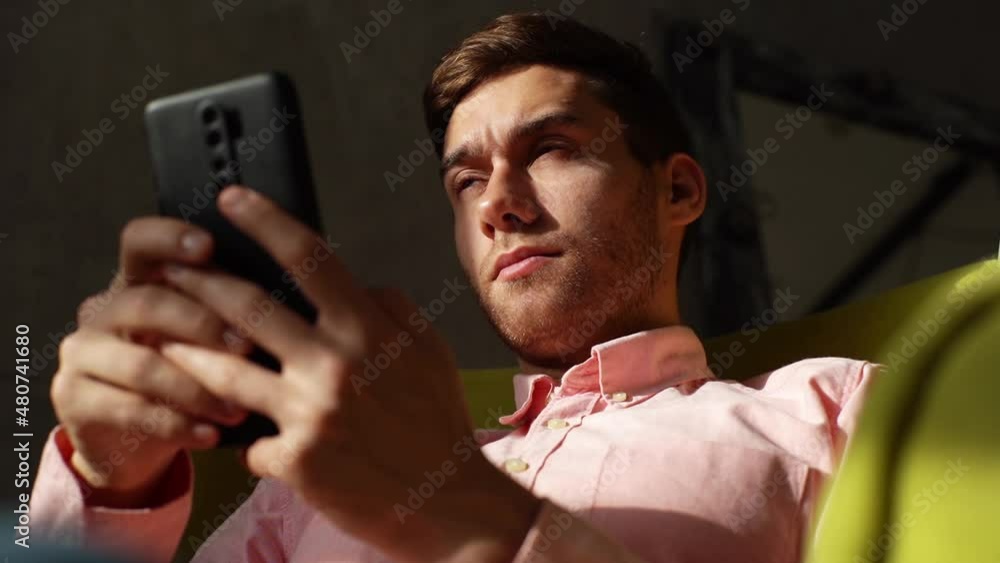 Close up of tired young man having blurry vision is rubbing and