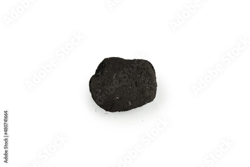 Black oak coal isolated on white background. © Nikolay