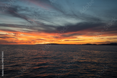 Calm golden sunset on open water while sailing the atlantic ocean