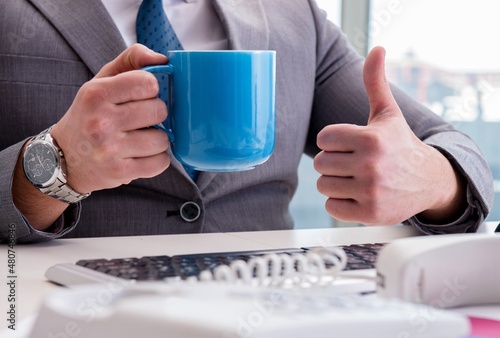 Businessman drinking coffee in the office