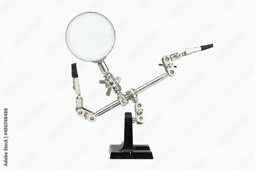 Old soldering iron stand with magnifying glass isolated on a white background Old soldering iron stand with magnifying glass isolated on a white background