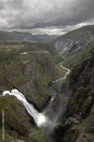 Voringfossen waterfall and the river under a cloudy sky landscape