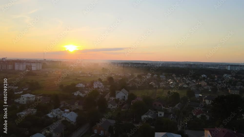 Aerial view of residential houses in suburban rural area at sunset Aerial view of residential houses in suburban rural area at sunset