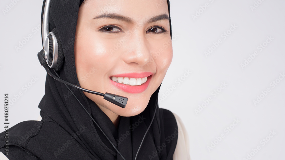 Customer service operator muslim woman in suit wearing headset over white background studio. Customer service operator muslim woman in suit wearing headset over white background studio.