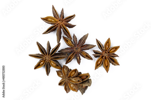 Anise stars on a white background top view. Dry spices for culinary dishes. Dried anise stars with seeds.