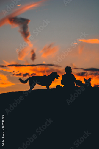 The man chilling at the sunset with his dogs  © Kaan