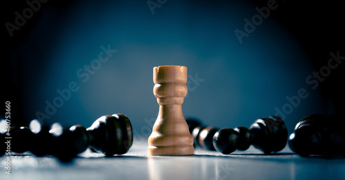 Victory, defense and self-confidence concept. White rook is the last chess piece standing. photo
