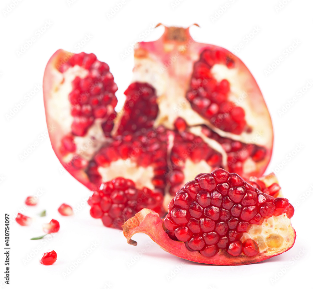 Juicy pomegranate and its half with leaves. Isolated on a white background. Juicy pomegranate and its half with leaves. Isolated on a white background.