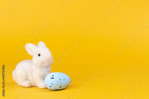 Easter bunny postcard or greeting card for spring holiday. Bright yellow background with copy space, free space for text photo
