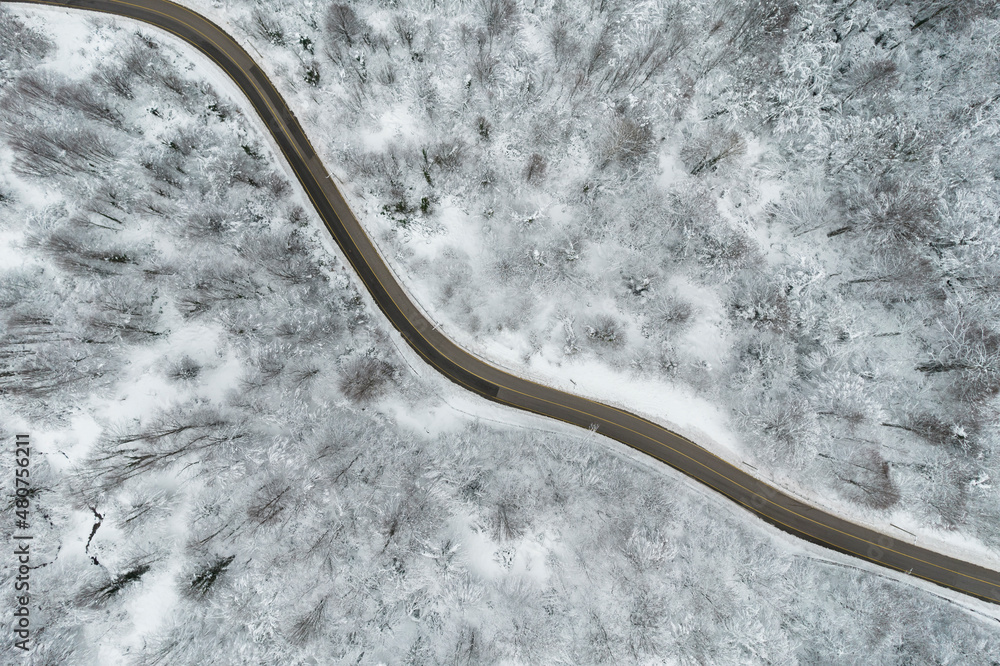 KARTEPE, KOCAELI, TURKEY. Beautiful winter landscape aerial view. Winter snowy forest with winding mountain road view. Drone Shot.
