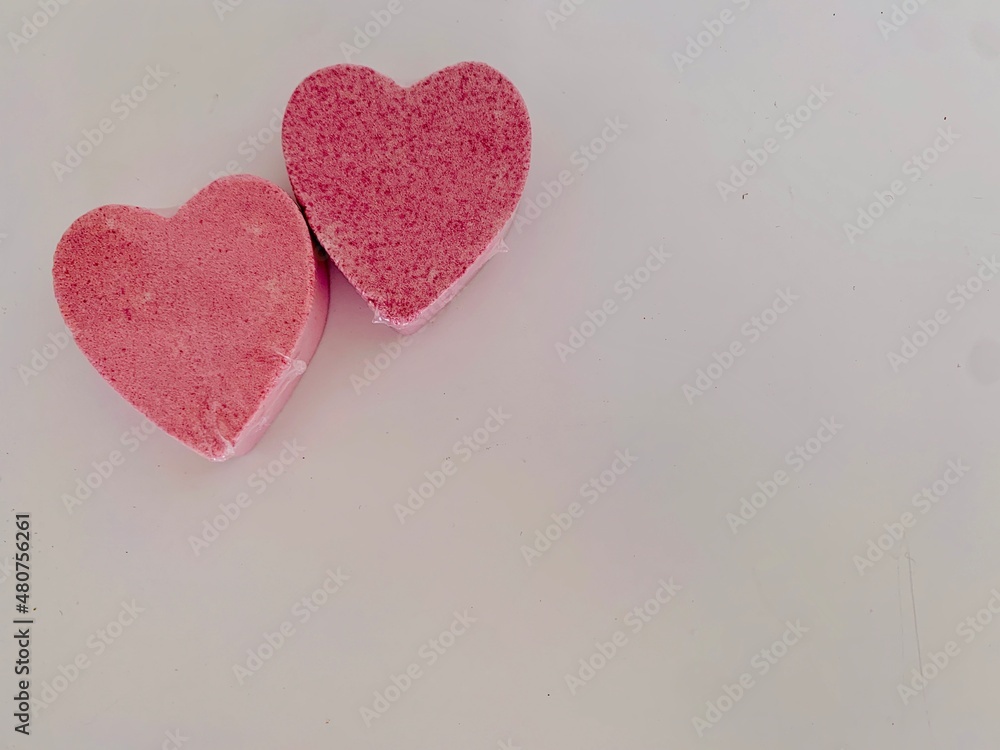 2 pink hearts on white background 2 pink hearts on white background