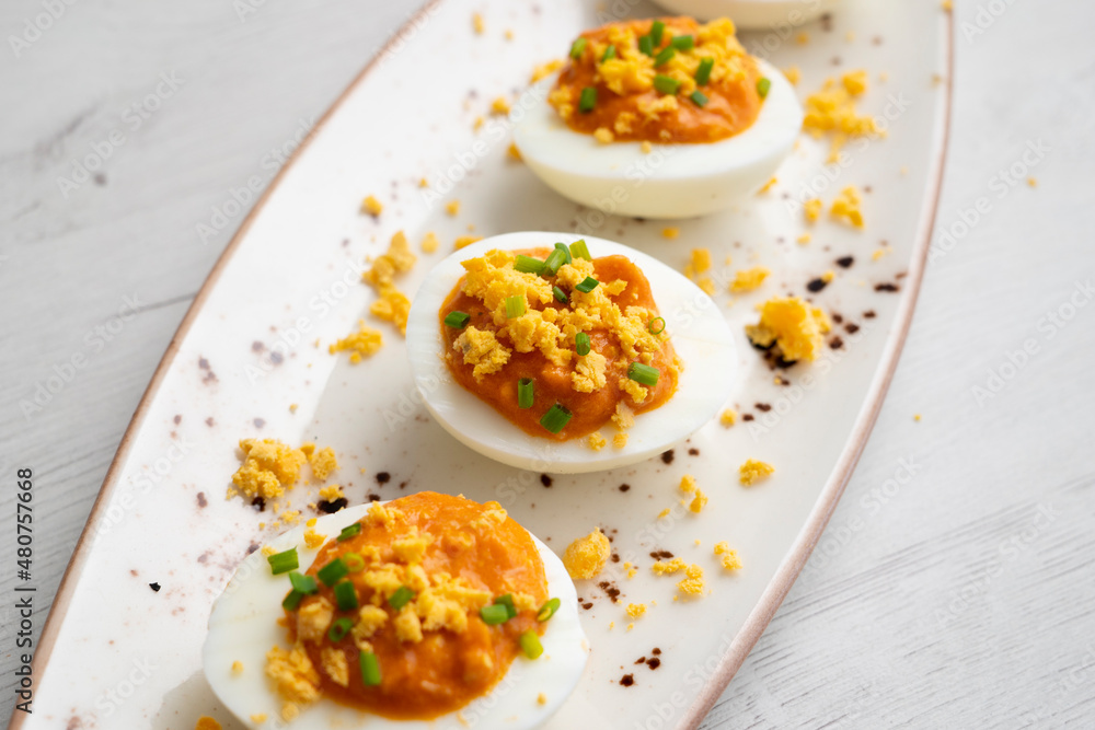 Stuffed eggs with tomato sauce and tuna. Spanish traditional tapas. Stuffed eggs with tomato sauce and tuna. Spanish traditional tapas.