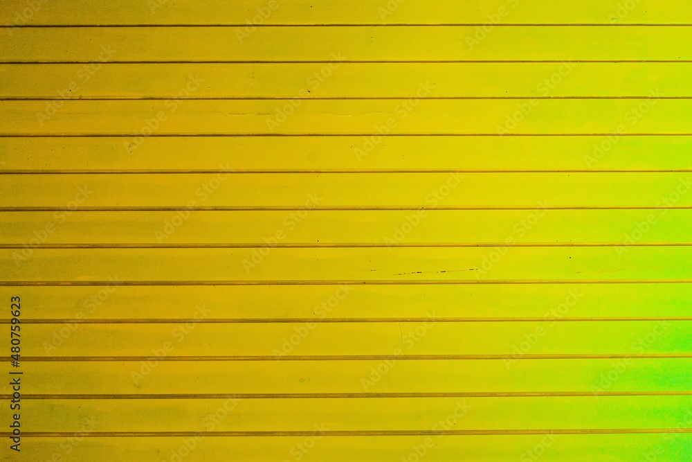 Fototapeta premium New yellow painted wooden wall or fence, background texture.