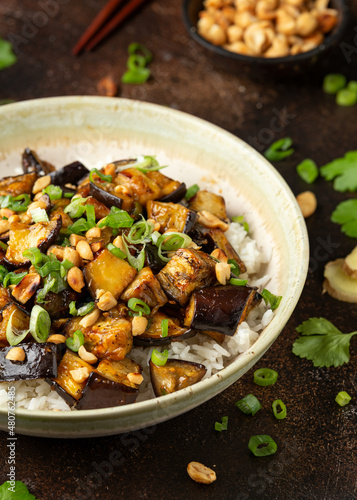 Asian Eggplant with rice, peanuts and spring onion. Healthy food.