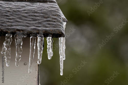 Freezing rain on a rooftop, with icicles