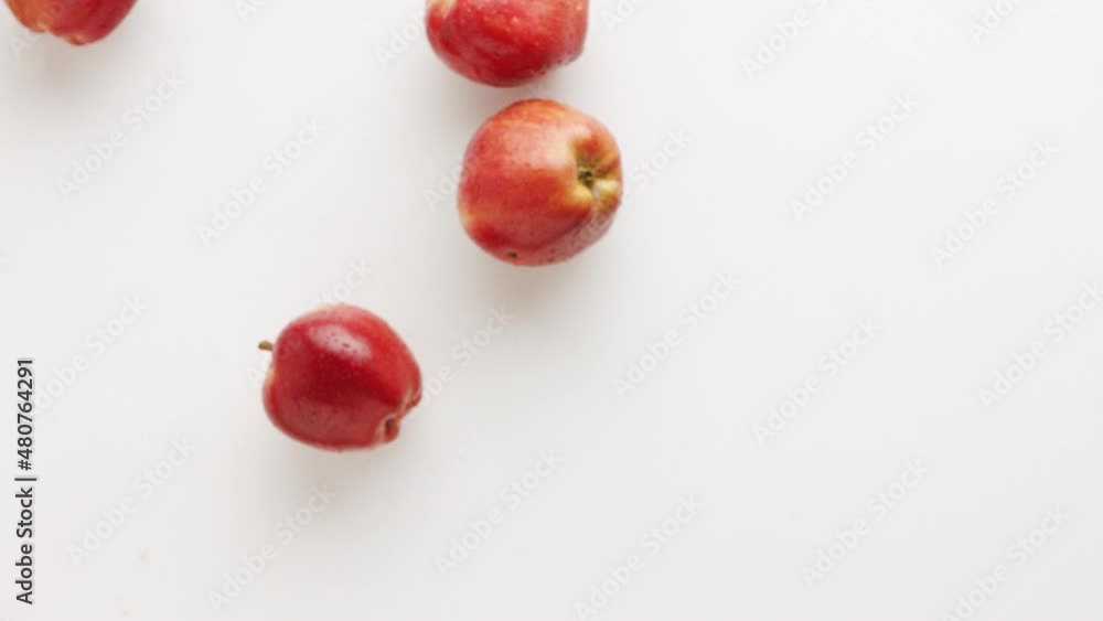 Many red apples, filmed on a white background, jump up and fly,for a Tasty Juice Many red apples, filmed on a white background, jump up and fly,for a Tasty Juice