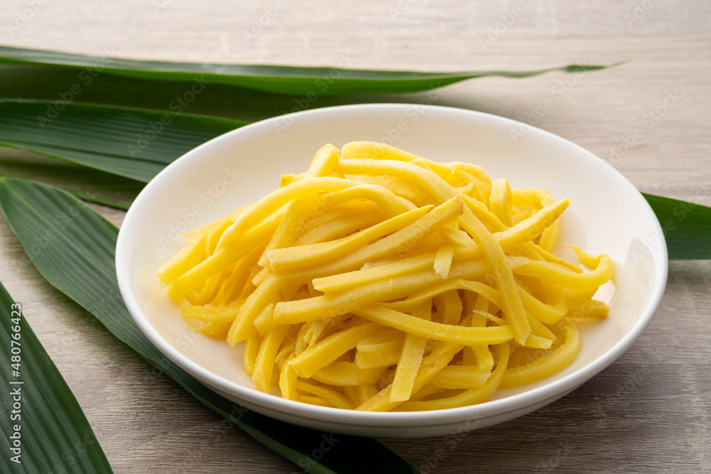 Close up sliced yellow Pickled bamboo shoots on white plate Close up sliced yellow Pickled bamboo shoots on white plate