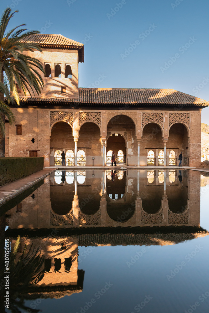 Vertical picture about El Partal in Alhambra, Granada, Spain. The monument is reflected on the pool. Sunny december's day in Alhambra.