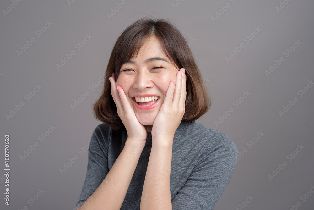 Portrait of young beautiful asian woman over studio background. Portrait of young beautiful asian woman over studio background.