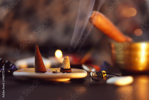 Burning aromatic incense smoky stick for meditation and relaxingon on abstract background © Olga Kazanovskaia 
