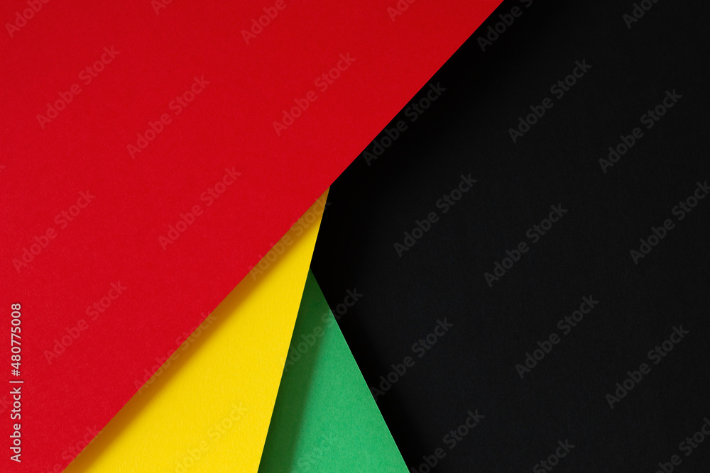 Abstract geometric black, red, yellow, green color paper background. Black History Month color background with copy space for text Abstract geometric black, red, yellow, green color paper background. Black History Month color background with copy space for text