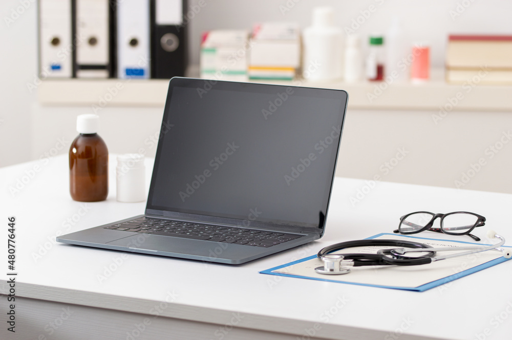 Cropped shot of technology and a notebook on a desk in an empty hospital office during the day Cropped shot of technology and a notebook on a desk in an empty hospital office during the day