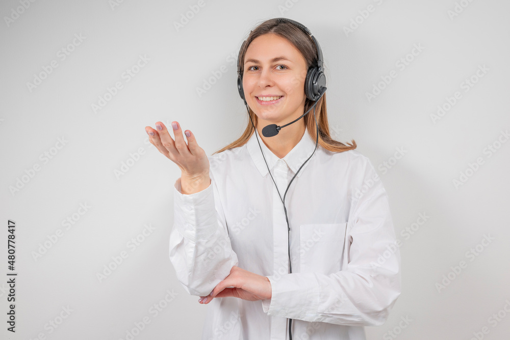 Portrait of smiling support female phone operator in headset, against grey background. Consulting and assistance service call center. Portrait of smiling support female phone operator in headset, against grey background. Consulting and assistance service call center.