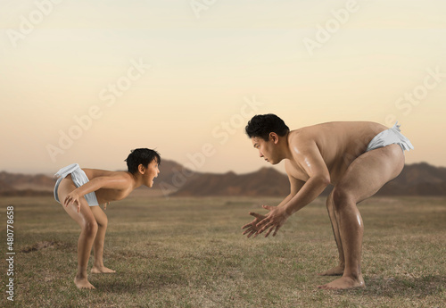 Two sumo wrestlers. Big and little