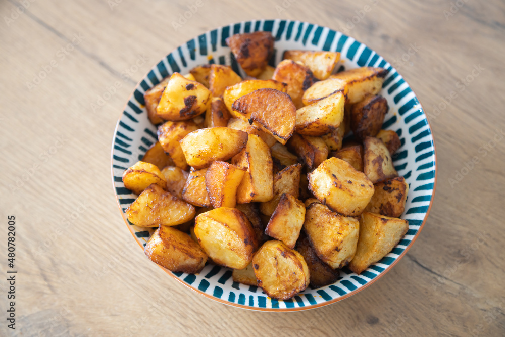 Roasted potatoes served in bowl Roasted potatoes served in bowl