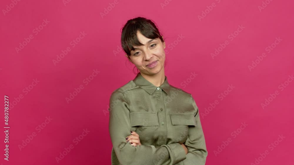 Pretty woman keeping the arms crossed in confident expression over isolated background Pretty woman keeping the arms crossed in confident expression over isolated background