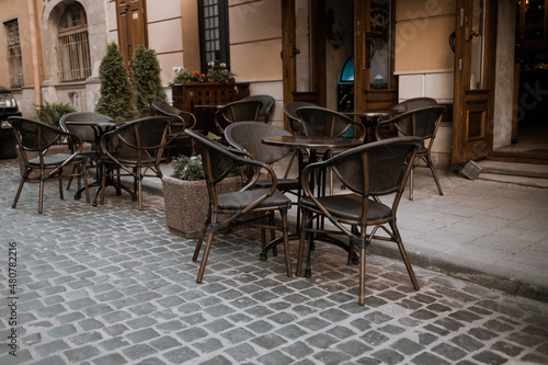 Empty tables of outdoor cafe in old city center of Lviv  Ukraine in Europe