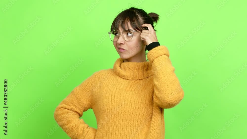 Pretty woman having doubts while scratching head over isolated background. Green screen chroma key Pretty woman having doubts while scratching head over isolated background. Green screen chroma key