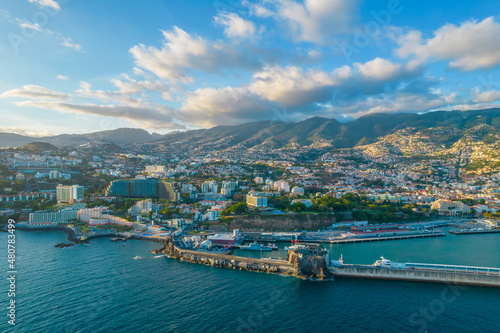 Aerial drone view of Funchal city center panorama in Madeira island in the evening. It's Portugal's Autonomous Region and is located in Atlantic ocean © Audrius
