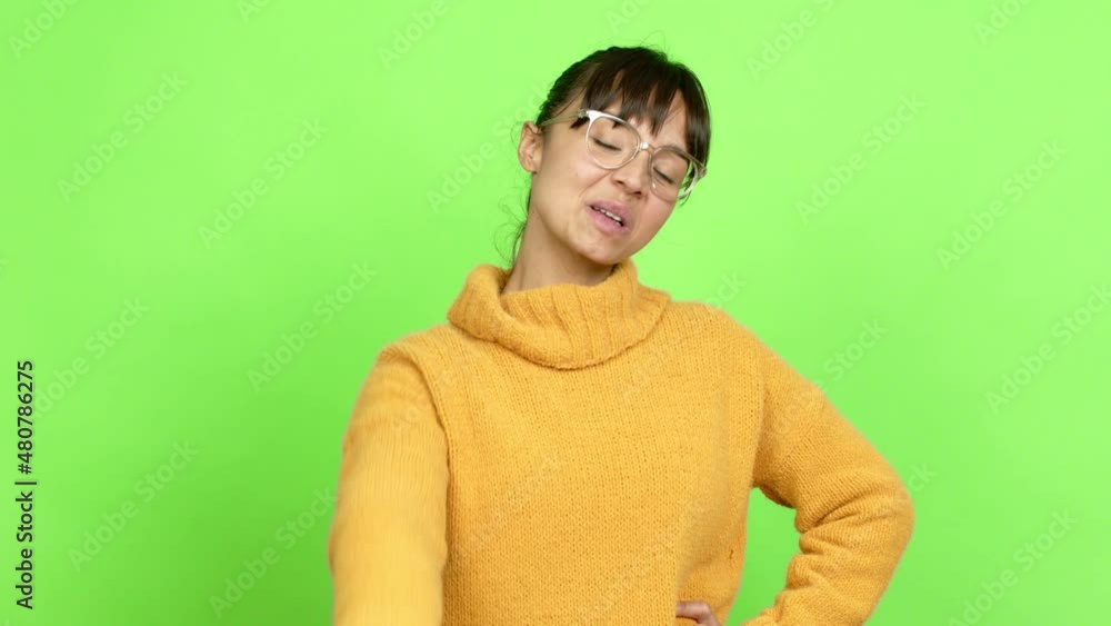 Pretty woman showing and lifting a finger in sign of the best over isolated background. Green screen chroma key Pretty woman showing and lifting a finger in sign of the best over isolated background. Green screen chroma key