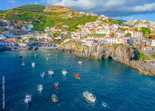 Aerial drone view of Camara de Lobos village panorama near to Funchal, Madeira. Small fisherman village with many small boats in a bay photo