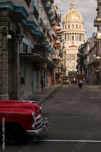Amazing old american car on streets of Havana with Capitolio Building in background during the day. Havana, Cuba.