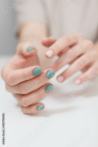 Beautiful female hands. Fresh manicure on the light backgroung