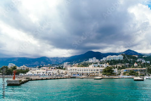 The seaport of the city of Yalta and the ships, yachts and pleasure boats parked in it, in good sunny weather. Yalta, July, 2018.