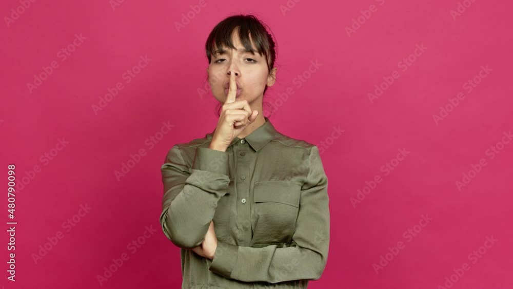 Pretty woman doing silence gesture over isolated background Pretty woman doing silence gesture over isolated background