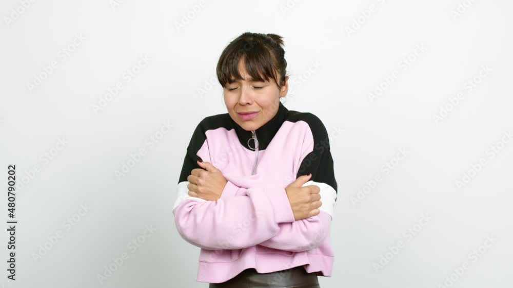 Pretty woman freezing over isolated background Pretty woman freezing over isolated background