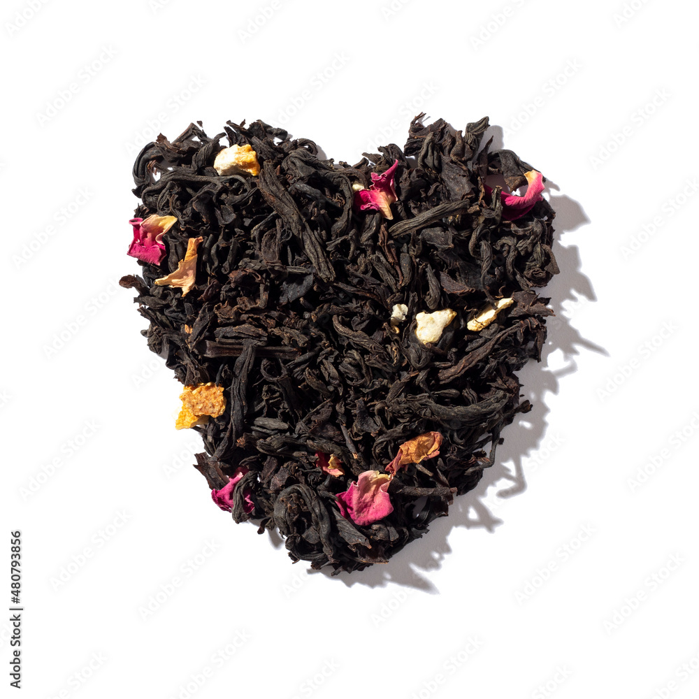 Heart shaped heap of dried black tea isolated on white background. Top view. Heart shaped heap of dried black tea isolated on white background. Top view.