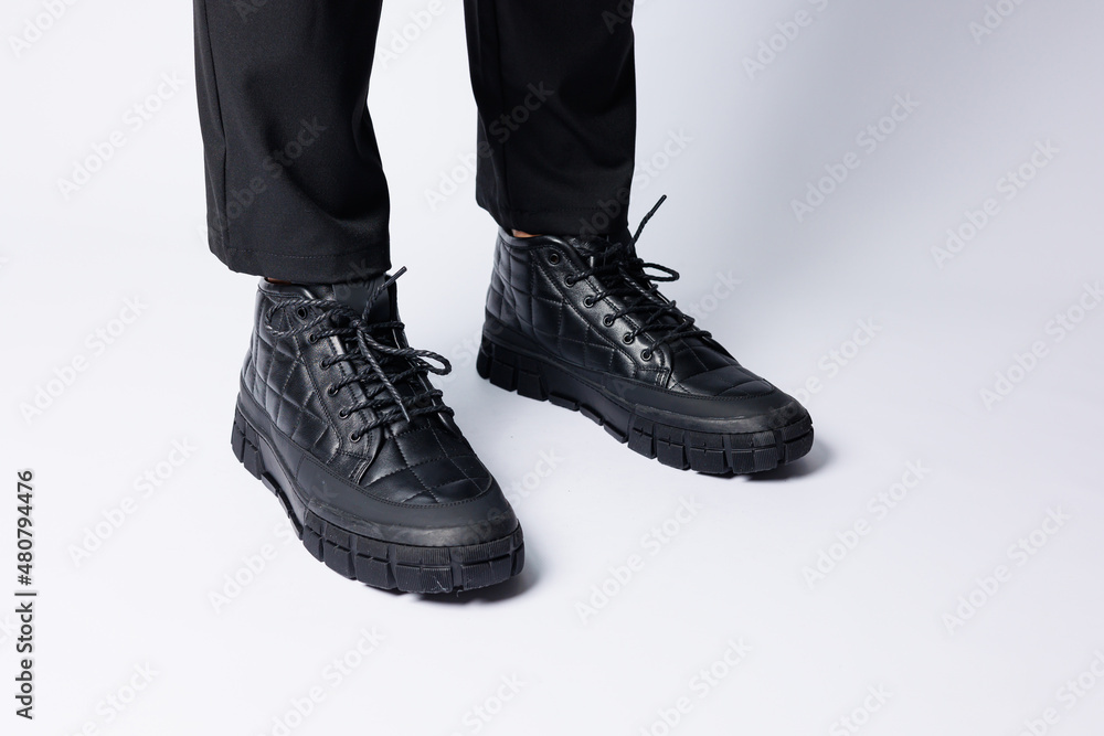 Men's black boots made of genuine leather, men's footwear on a white background. Winter men's shoes 2022 Men's black boots made of genuine leather, men's footwear on a white background. Winter men's shoes 2022