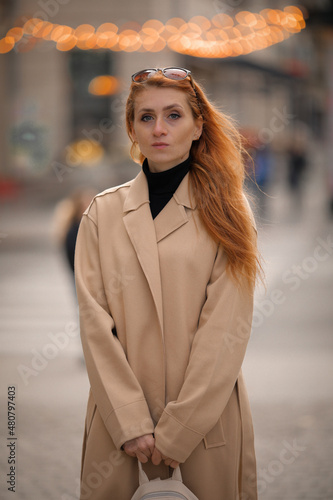 woman walking down the street. walk through the autumn city  © Svetlana