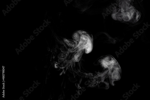 Beautiful abstract cloud of smoke isolated on black background. White smoke glow in the dark, steam gushing to form free shapes. © raland
