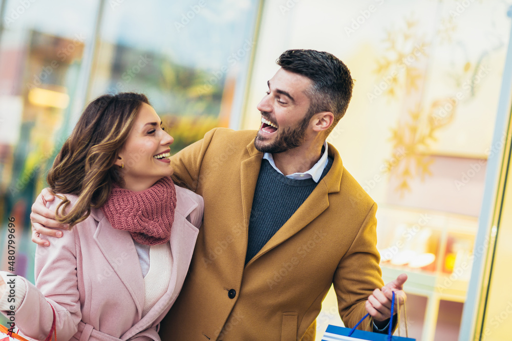 Young happy couple after shopping holding a credit card Young happy couple after shopping holding a credit card